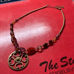 Red bead necklace with metal medallion